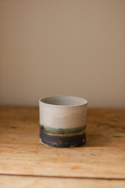 Handmade ceramic plant pot with copper oxide brushed base and matte white glaze, ideal for houseplants, succulents, or decorative home styling.